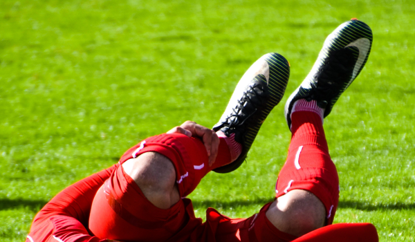 a football player holding his ankle