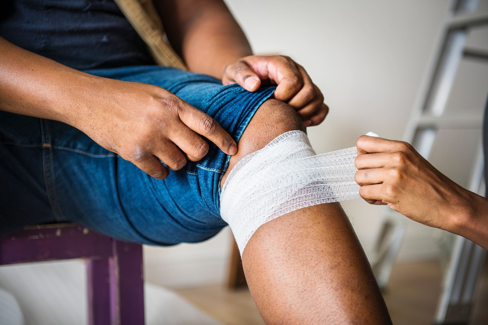 a man getting his knee bandaged