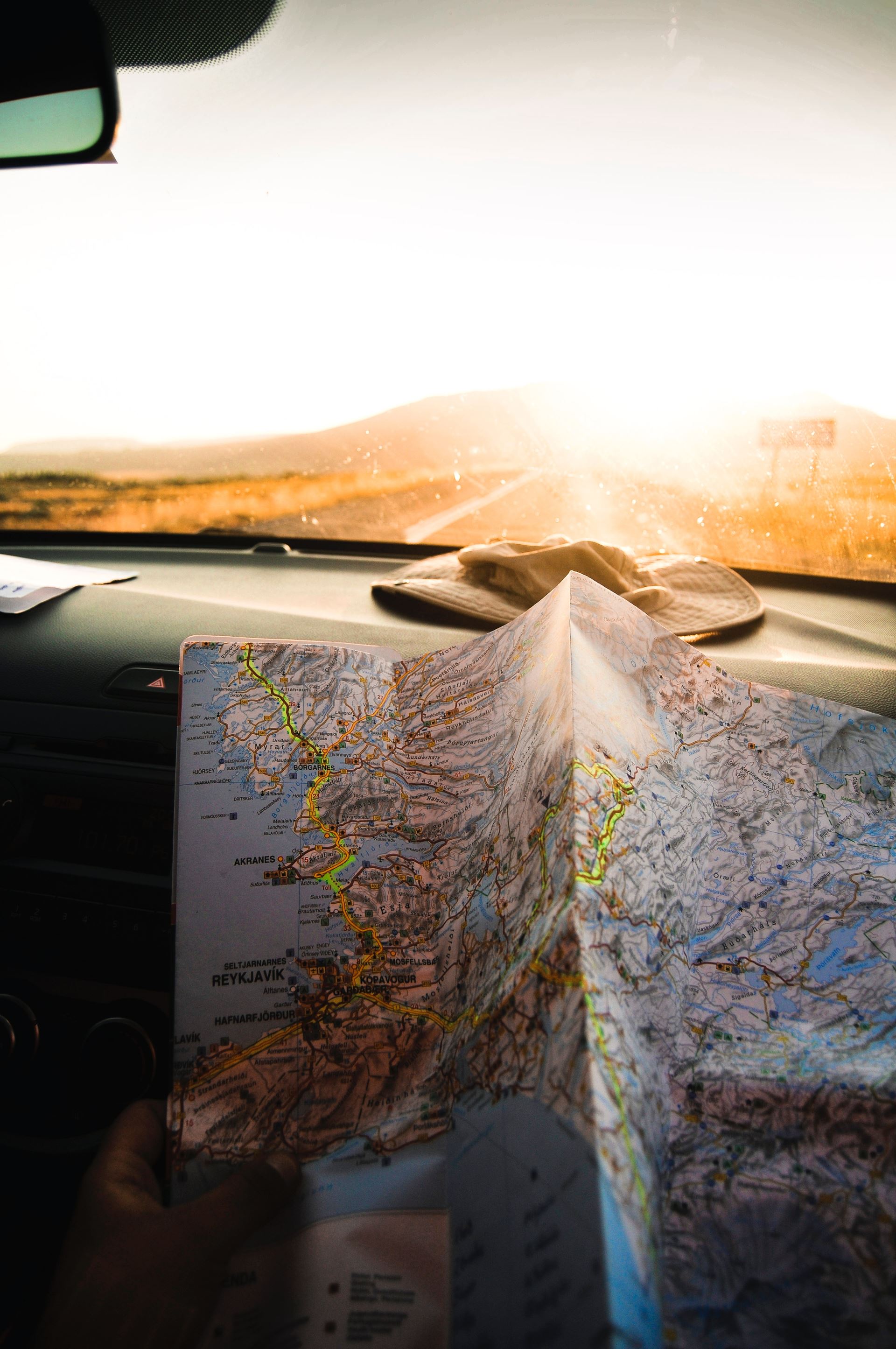 a person with a map in the car